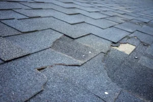 Close Up Of Asphalt Shingle Granule Loss From UV Exposure