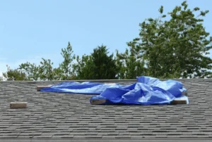 Properly Secured Tarp Covering A Storm Damaged Roof Section
