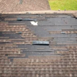 Storm Damaged Asphalt Shingle Roof With Missing Shingles