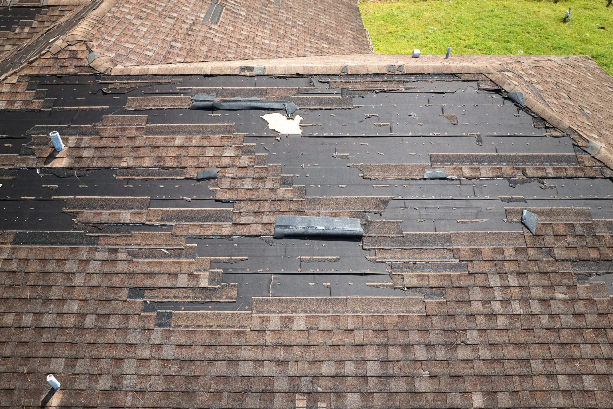 Storm Damaged Asphalt Shingle Roof With Missing Shingles